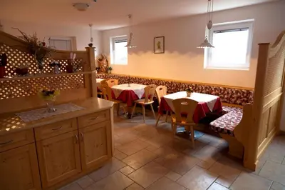 a dining room with two tables and two chairs at Ciasa Raut in La Valle