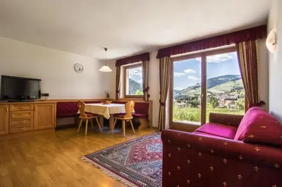 a living room with a couch and a table at Ciasa Isidor in San Vigilio Di Marebbe