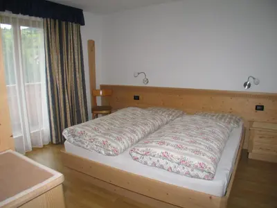 a large bed in a bedroom with at Ciasa Isidor in San Vigilio Di Marebbe
