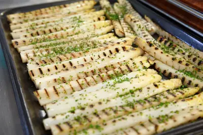 a tray full of cheese sticks with greens on them at Hotel Neuhausmühle in Vilpiano