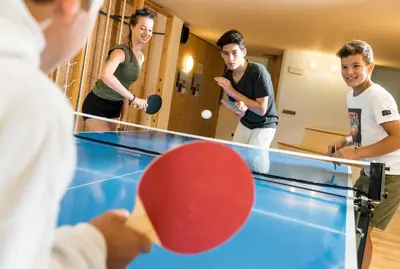 a group of people playing a game of ping pong at Bad Ratzes in Siusi