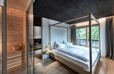 a bedroom with a canopy bed and a window at Bad Ratzes in Siusi