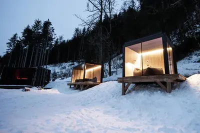 a couple of tiny houses in the snow at Bad Ratzes in Siusi