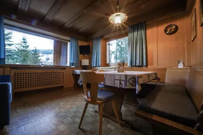 a living room with a table and a chair at Aria D'Bosch in Badia