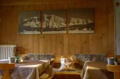 a restaurant with two tables and a picture on the wall at Lamirì in Badia