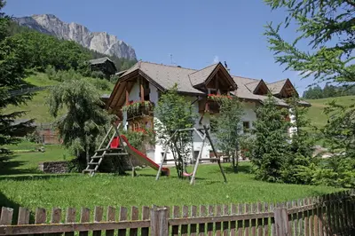 a house with a playground in front of it at Aria d' Prè in Badia