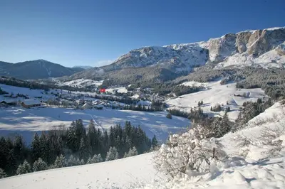 a snow covered mountain with a town and a lake at Aria d' Prè in Badia
