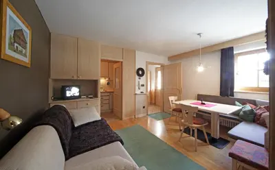 a living room with a couch and a table at Aria d' Prè in Badia