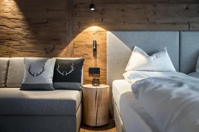 a bedroom with a bed with white sheets and pillows at Les Contrades in La Villa