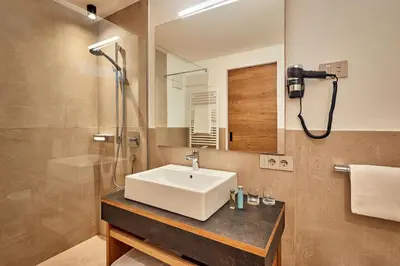 a bathroom with a sink and a mirror at Les Contrades in La Villa