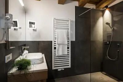 a bedroom with a bed and a sink at Les Contrades in La Villa