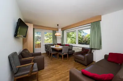 a living room with a couch and a table at AppartChalet LA RONDULA - 100m from Seceda in Ortisei