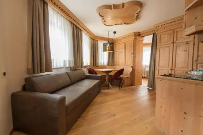 a kitchen with wooden cabinets and a sink at Appartments Peter in Colfosco