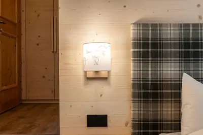a wall with a picture of a man on it at Residence Bosco Verde in San Cassiano