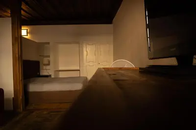 a small bedroom with a bed and a television at Residence Fink Central Apartments in Bolzano