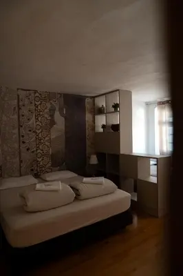 a bedroom with two beds and a window at Residence Fink Central Apartments in Bolzano