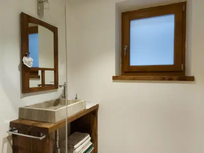 a bathroom with a sink and a mirror at CHALET VILLA RITA in Tesero
