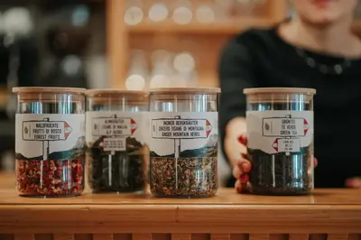 four jars of seeds sitting on a wooden shelf at B&B Hotel Mirabel in Ortisei