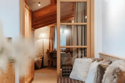 a living room with a loft bed and a couch at B&B Hotel Mirabel in Ortisei