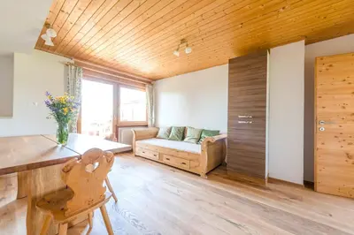 a living room with a bed and a couch at Tielerhof in Aldino