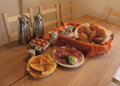 a table topped with plates of food on a table at Tielerhof in Aldino