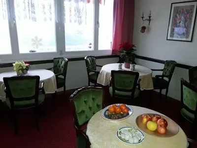 a dining room with two tables with fruit on them at Hotel Lux in Merano