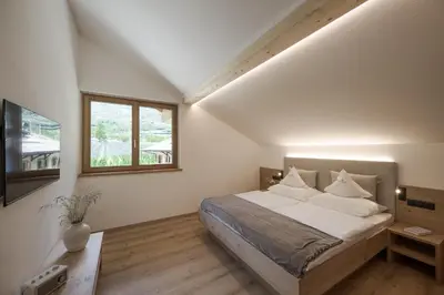 a bedroom with a bed and a window at Untermairhof in Lagundo