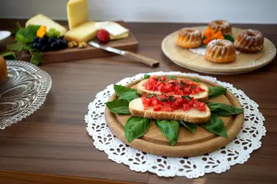 a table with a plate of food with sandwiches and muffins at Untermairhof in Lagundo
