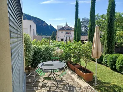 a patio with a table and an umbrella at Das Landhaus in Terlano