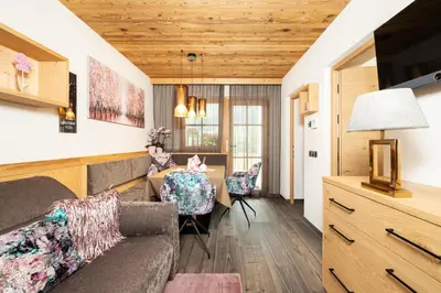 a living room with a couch and a table at Chalets 4 Sorus & Apartments La Villetta in Colfosco