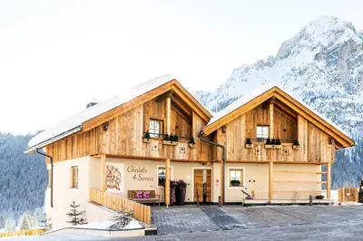 a house in the mountains with snow at Chalets 4 Sorus & Apartments La Villetta in Colfosco