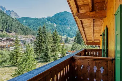a balcony with a view of the mountains at Majon del Tisler in Canazei