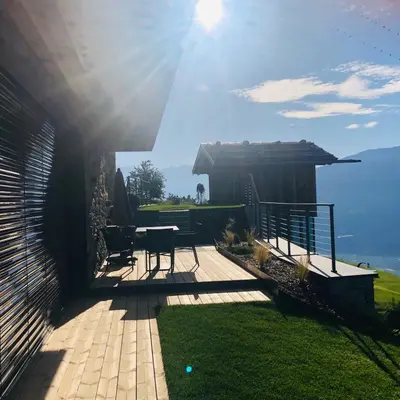 a patio with a table and a view of the ocean at Chalet in Naturno