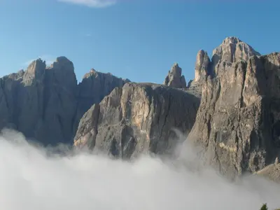a mountain range with clouds in the foreground at Residence Bondì in Colfosco