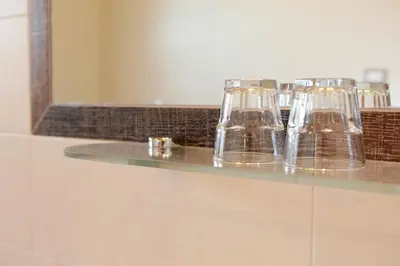 a row of glasses sitting on top of a counter at Garnì Iosc in San Vigilio Di Marebbe
