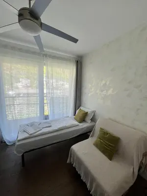 a bedroom with a bed and a ceiling fan at B&B Mele d'Oro in Bolzano