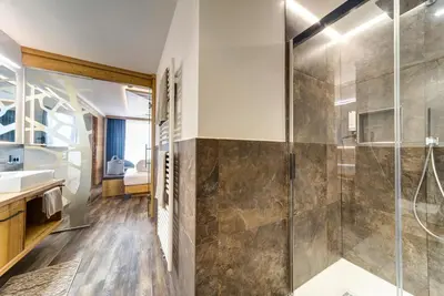 a bathroom with a shower and a sink at Hotel Muliac in Selva di Val Gardena