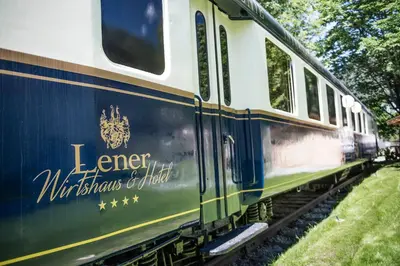 a blue and white train on the tracks at Luxury Lodge - Lener Express in Campo di Trens