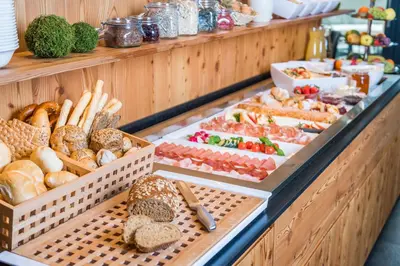 a buffet with different types of bread and other foods at Luxury Lodge - Lener Express in Campo di Trens
