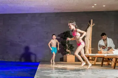 a young girl and boy are dancing on a stage at Luxury Lodge - Lener Express in Campo di Trens