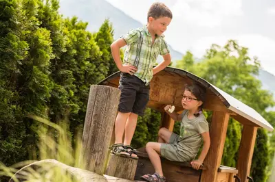 a young boy standing on top of a play house at Luxury Lodge - Lener Express in Campo di Trens