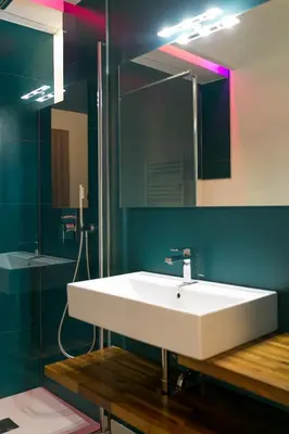 a bathroom with a white sink and a mirror at Apartment Vanga in Bolzano