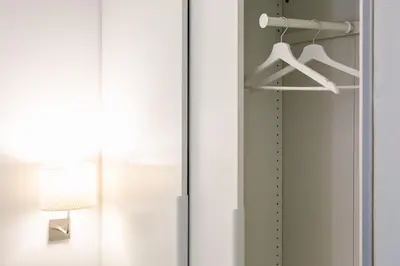 a closet with white doors and a lamp at Apartment Vanga in Bolzano