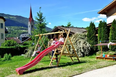 a group of children playing on a playground at Rumlhof in Bressanone
