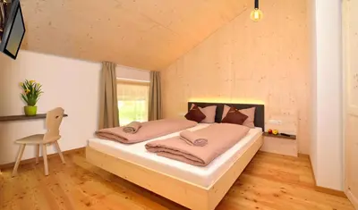 a bedroom with a large bed in a room at Rumlhof in Bressanone