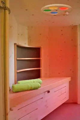 a wooden cabin with a bed in a room at Rumlhof in Bressanone