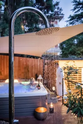 a water fountain on a deck with a table at Villa Helvetia in Merano