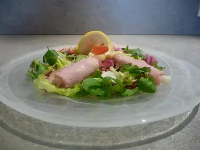 a plate of food with a salad on a table at Kleinkunsthotel in Naturno