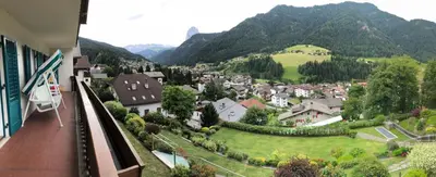 a view of a town with mountains in the background at Appartements Arnica in Ortisei