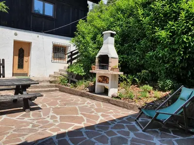 a brick patio with a fireplace and a bench at Burgerhof in San Genesio Atesino